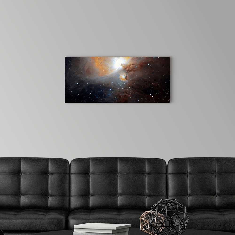 A modern room featuring Space photograph of a large, bright nebula of swirling clouds dotted with stars in the constellat...
