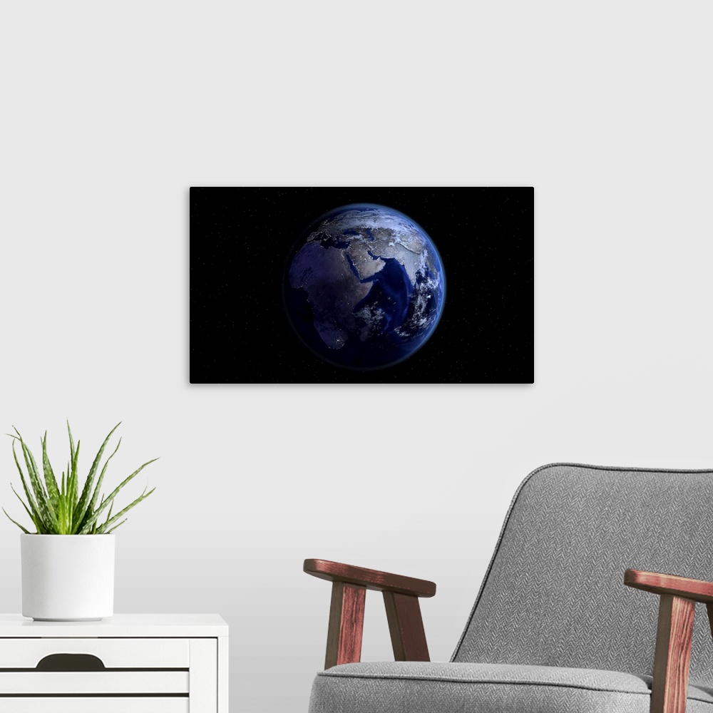 A modern room featuring Planet Earth showing Africa, Europe and Asia, half night and half day with city lights