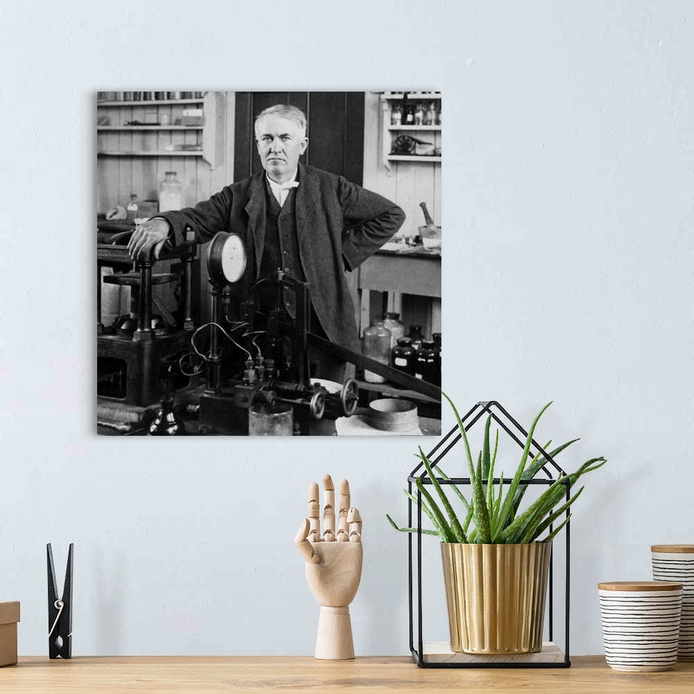 A bohemian room featuring Portrait of American inventor Thomas Edison, posed inside his workshop, dated 1901.