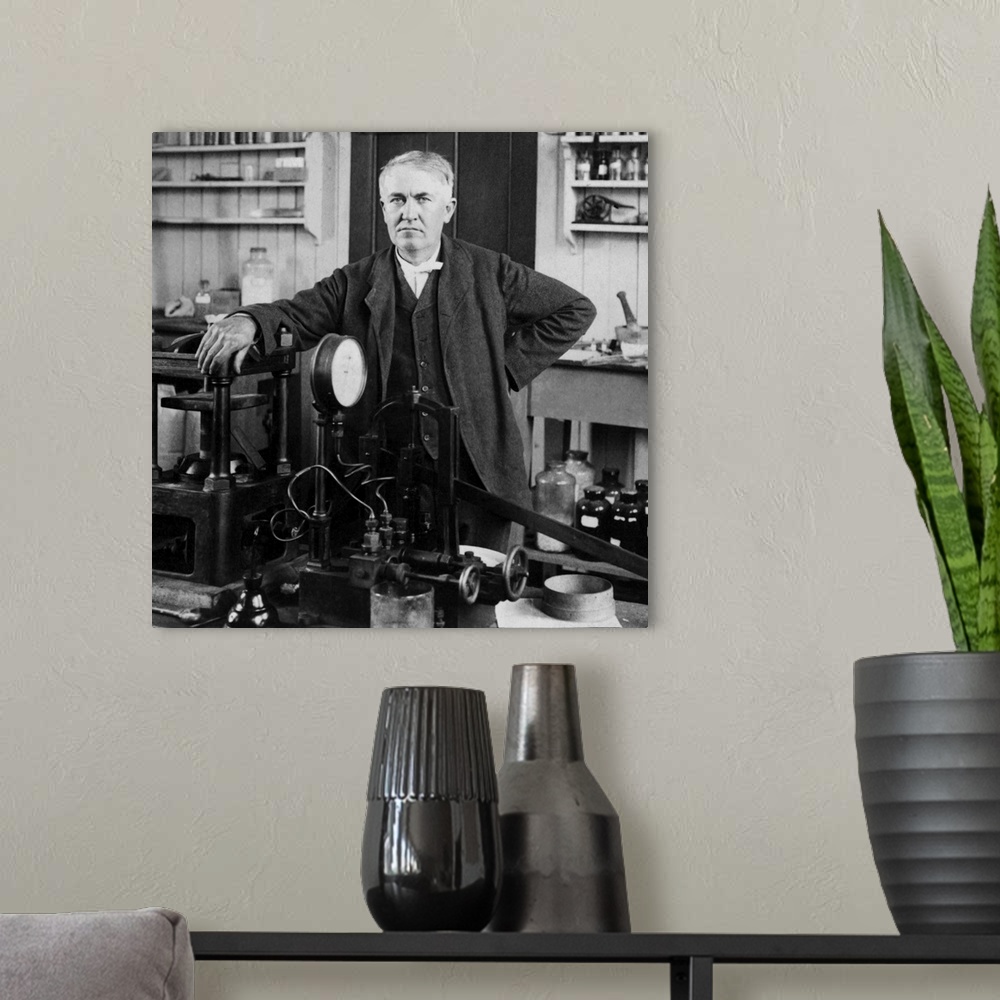 A modern room featuring Portrait of American inventor Thomas Edison, posed inside his workshop, dated 1901.