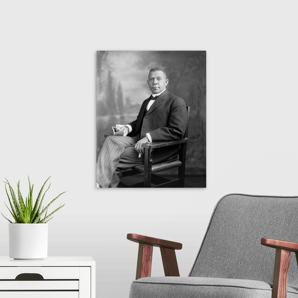 A modern room featuring Portrait of Booker T. Washington sitting in a chair.