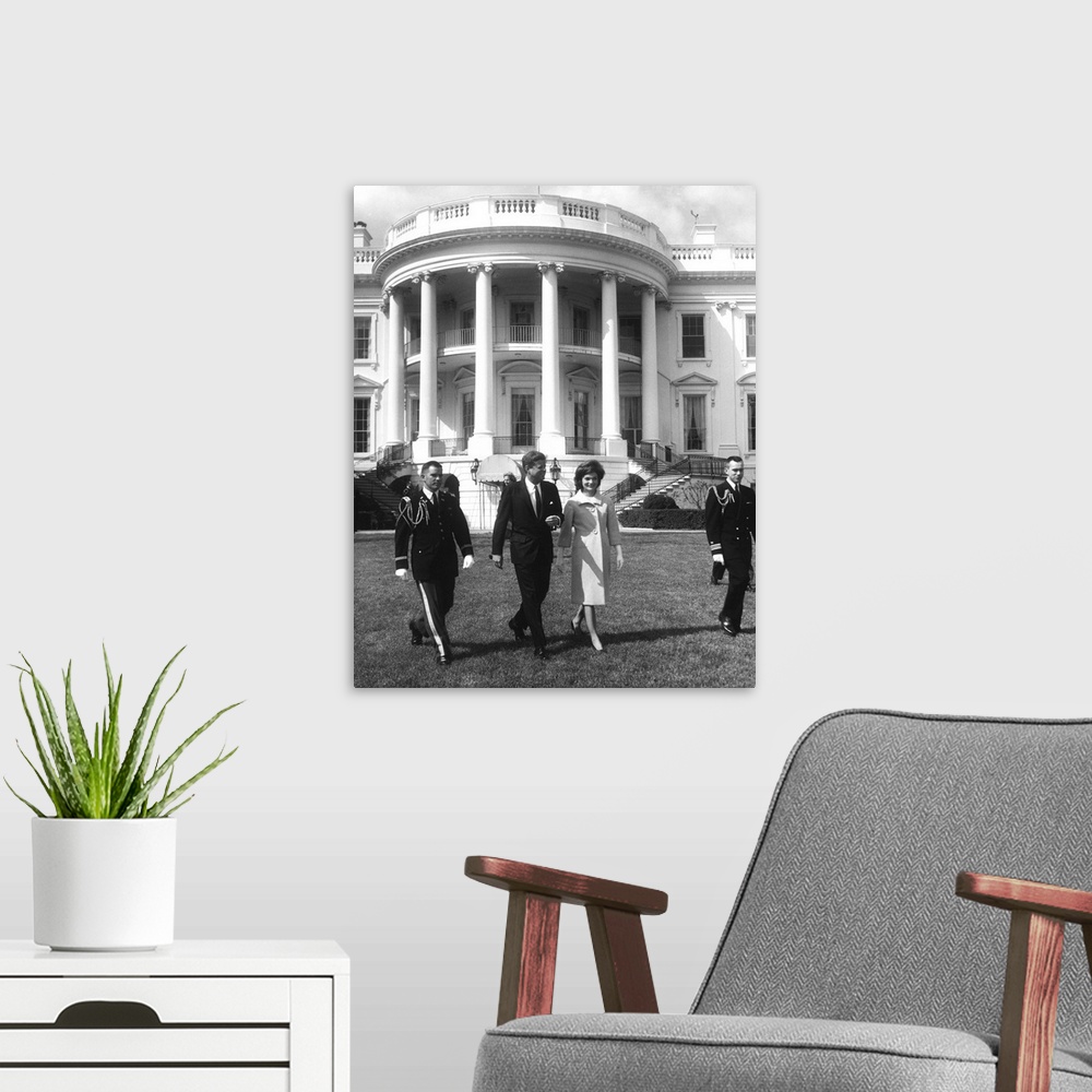 A modern room featuring President John F. Kennedy and the First Lady in front of White House.