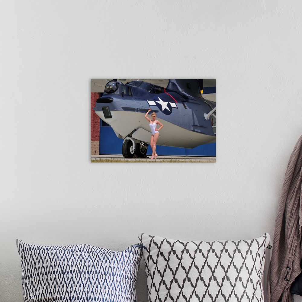 A bohemian room featuring Retro pin-up girl posing with a World War II era PBY Catalina seaplane.