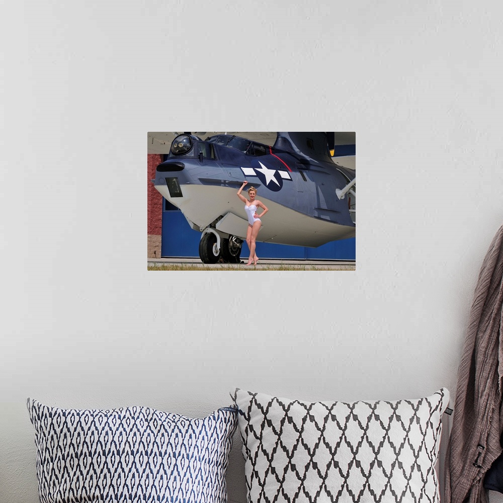 A bohemian room featuring Retro pin-up girl posing with a World War II era PBY Catalina seaplane.