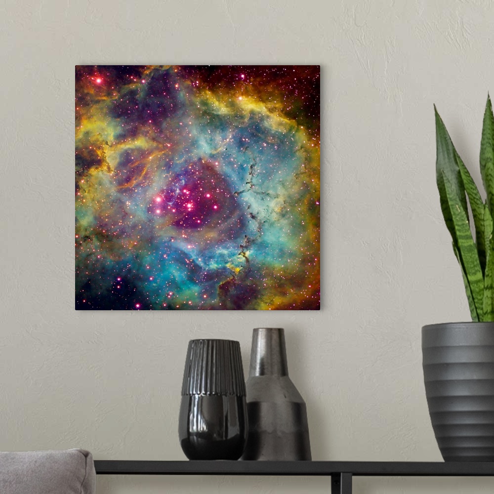 A modern room featuring Large square photograph taken of a star filled sky against the vibrant background of Rosette Nebu...