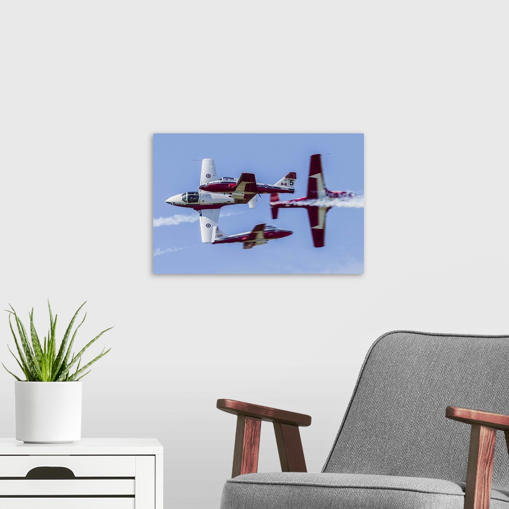 A modern room featuring Four Royal Canadian Air Force Tutor trainer aircraft of the Snowbirds display team cross at Wauke...