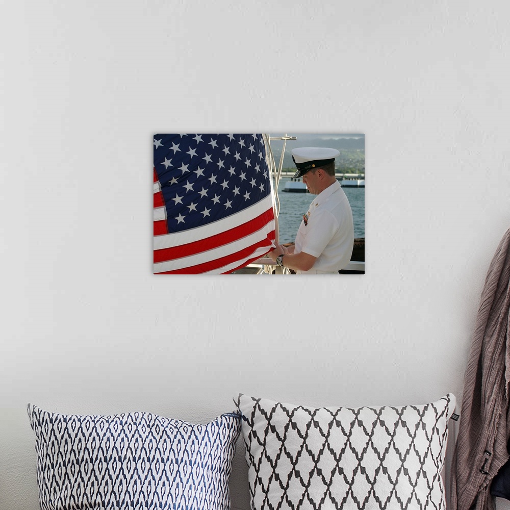 A bohemian room featuring Sailor raises an American flag above the USS Arizona Memorial in Pearl Harbor, Hawaii.