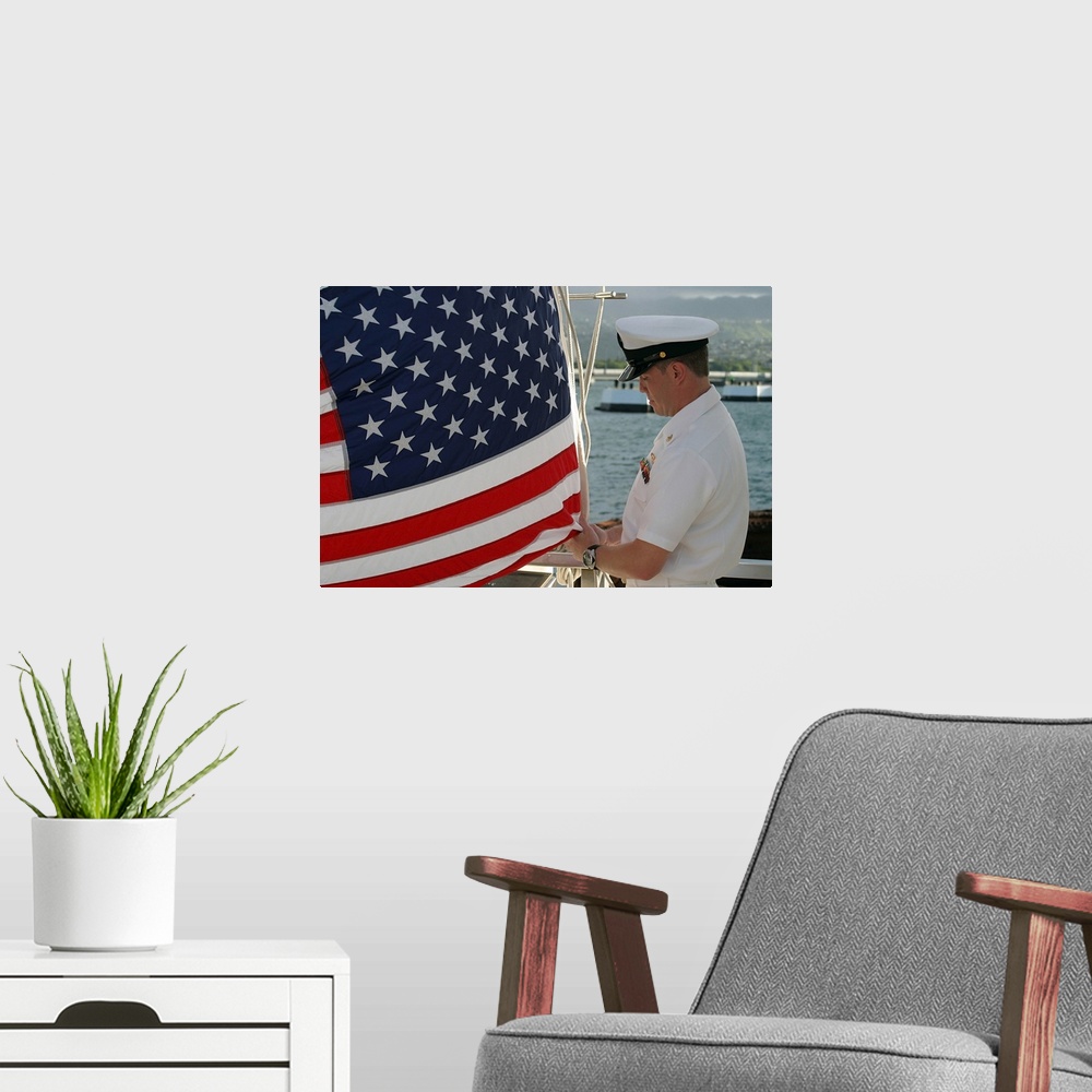 A modern room featuring Sailor raises an American flag above the USS Arizona Memorial in Pearl Harbor, Hawaii.