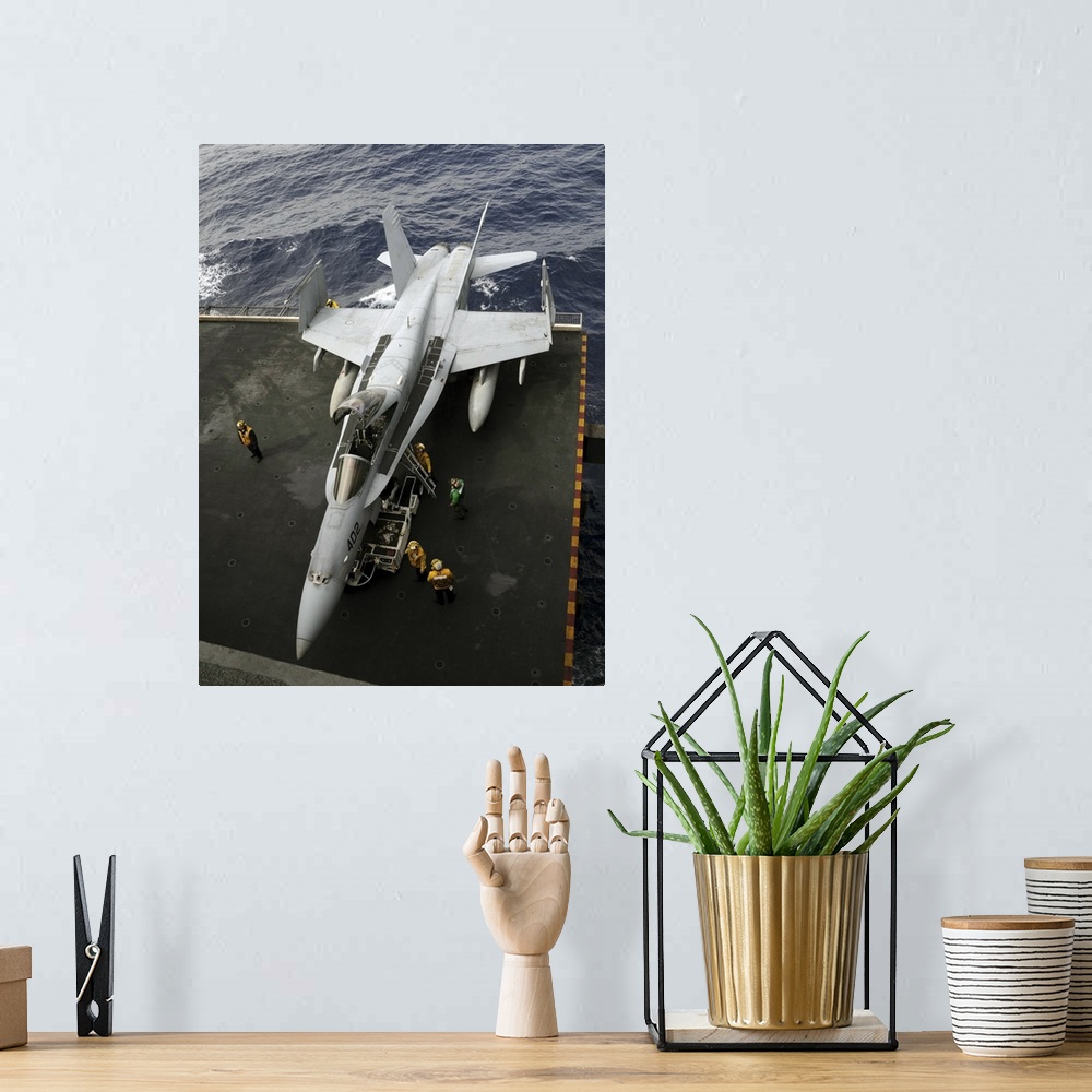 A bohemian room featuring Pacific Ocean, March 2, 2011 - Sailors move an F/A-18C Hornet from the elevator into the hangar b...