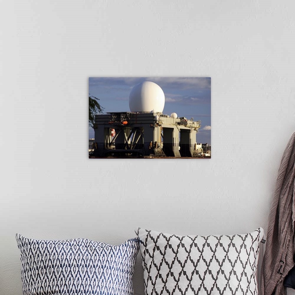 A bohemian room featuring Sea Based Xband Radar dome modeled by the setting sun at Pearl Harbor naval shipyard