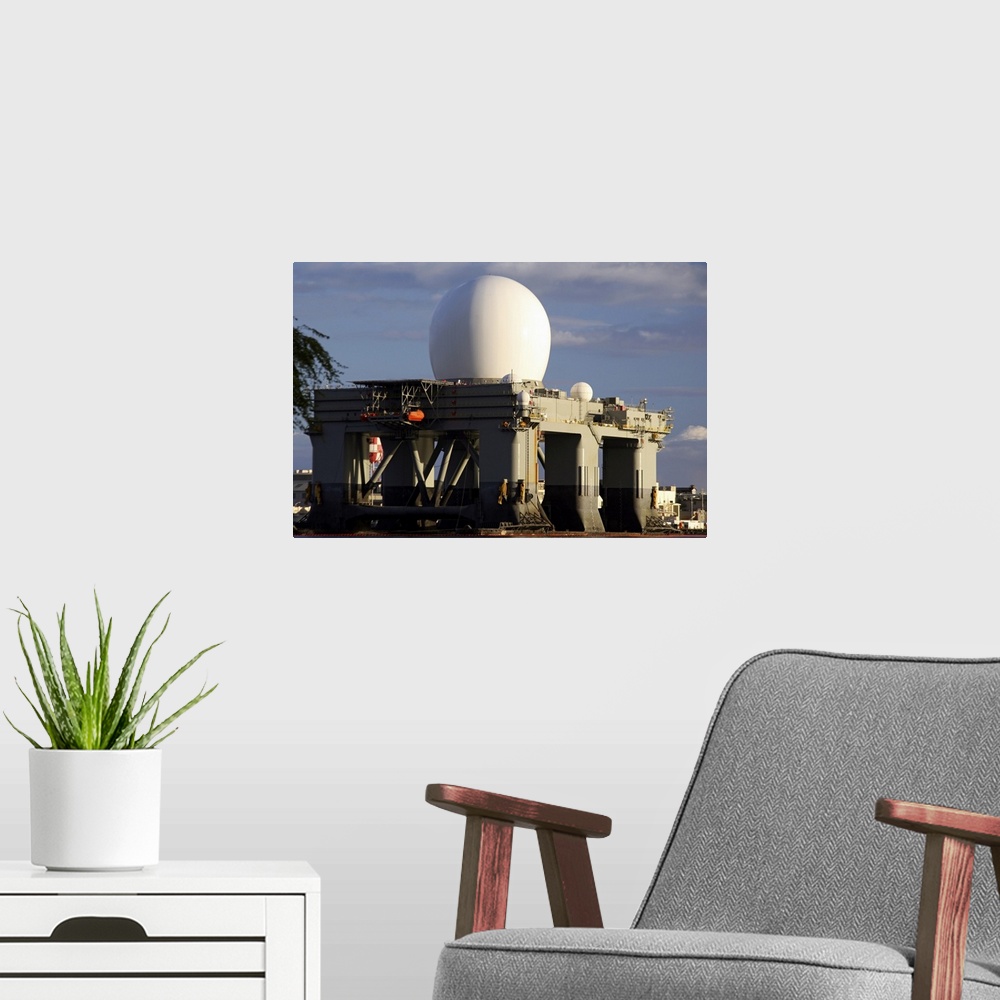 A modern room featuring Sea Based Xband Radar dome modeled by the setting sun at Pearl Harbor naval shipyard