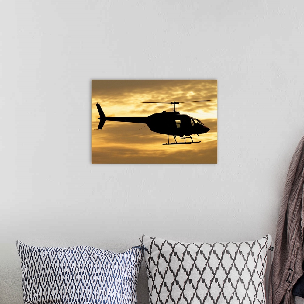 A bohemian room featuring Silhouette of a Bell 206 utility helicopter of Italy's Vigili del Fuoco flying over Italy.