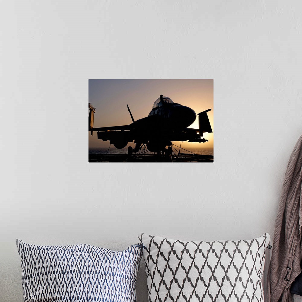 A bohemian room featuring Silhouette of a US Navy F/A-18E Super Hornet parked on the flight deck of aircraft carrier USS Ni...