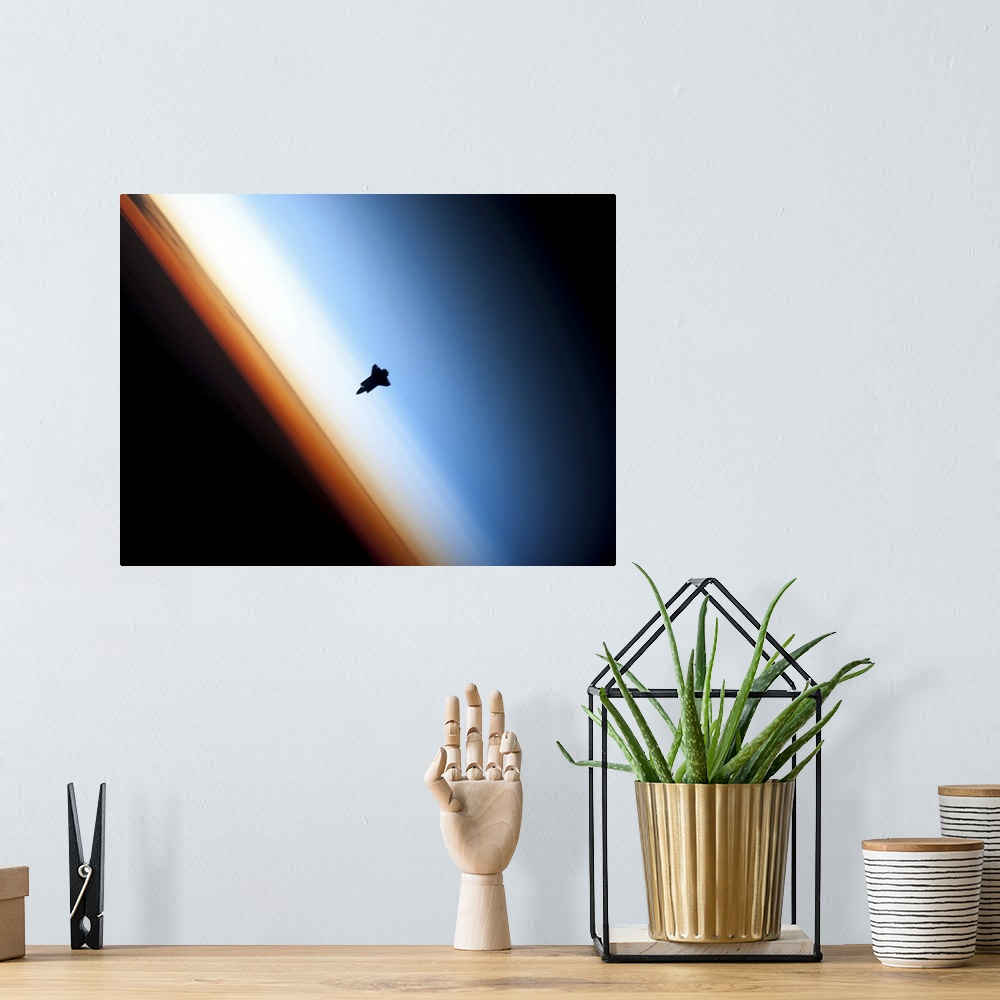 A bohemian room featuring Silhouette of space shuttle Endeavour over Earths colorful horizon