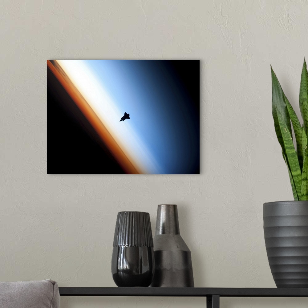 A modern room featuring Silhouette of space shuttle Endeavour over Earths colorful horizon