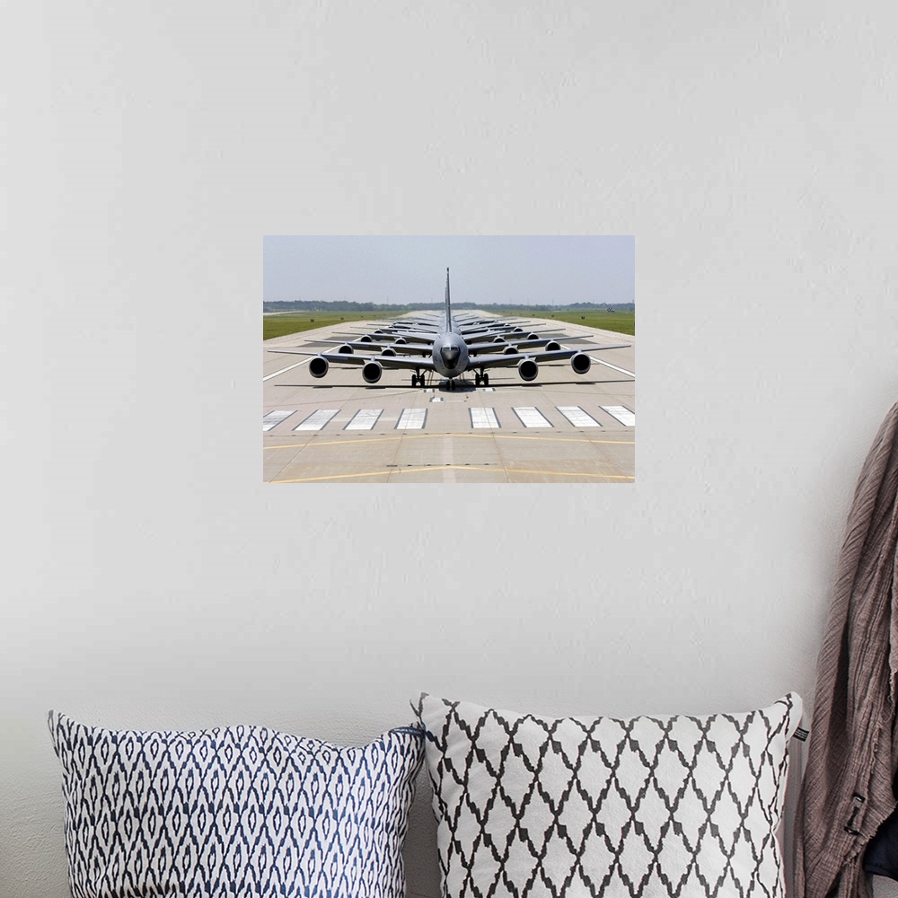 A bohemian room featuring Photograph of several large Stratotanker airplanes perfectly lined up in a row on a runway.