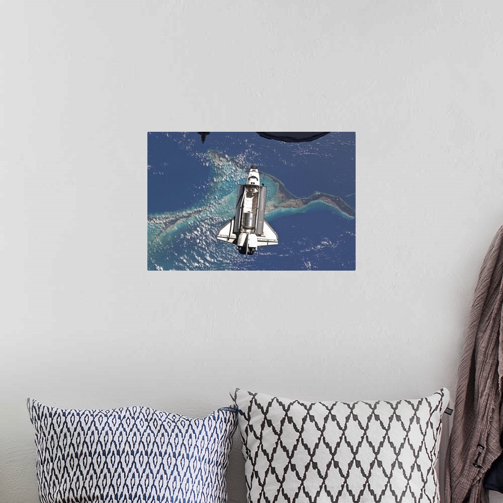 A bohemian room featuring July 10, 2011 - Space Shuttle Atlantis over the Bahamas. Part of a Russian Progress spacecraft is...