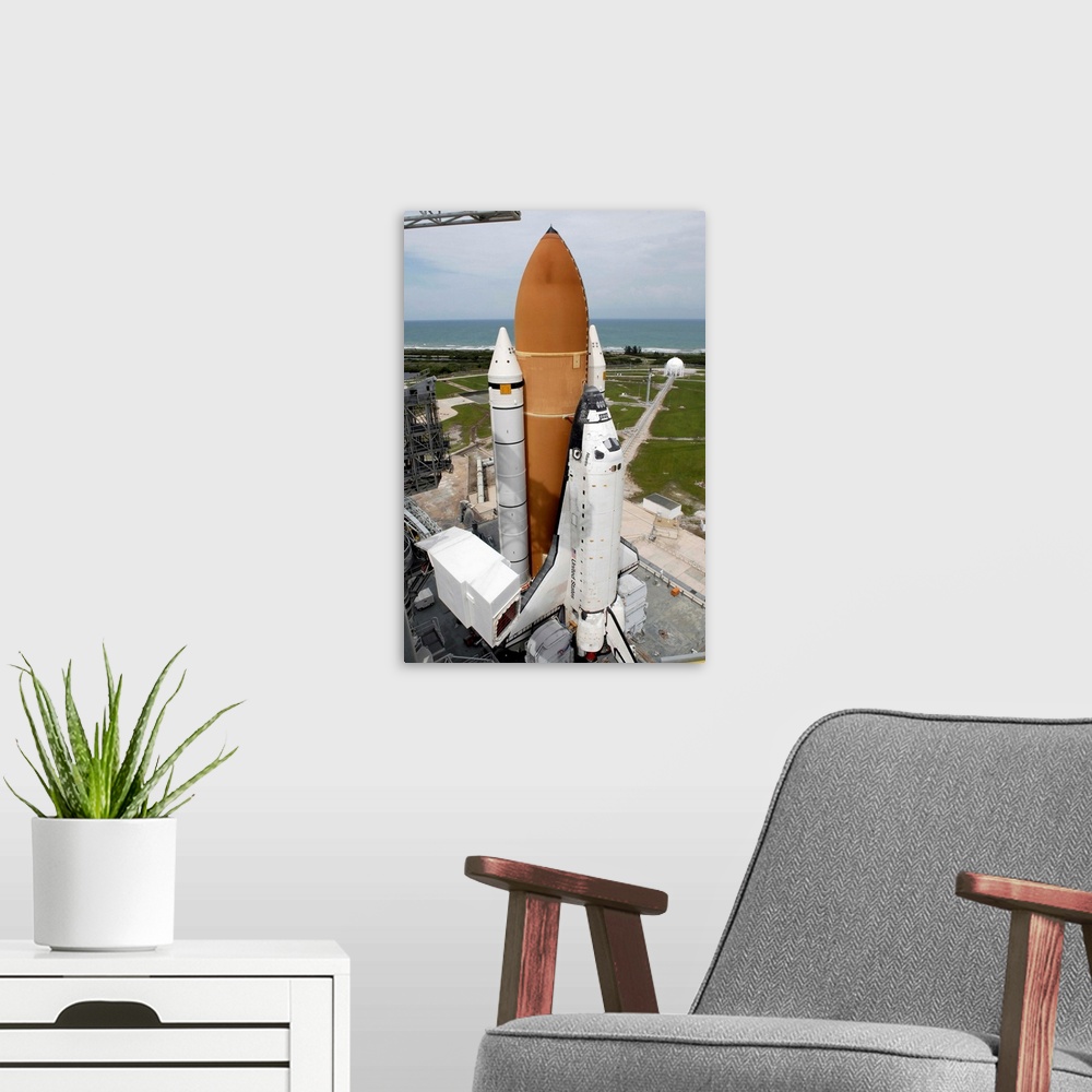 A modern room featuring Space shuttle Atlantis sits on the top of Launch Pad 39A at Kennedy Space Center