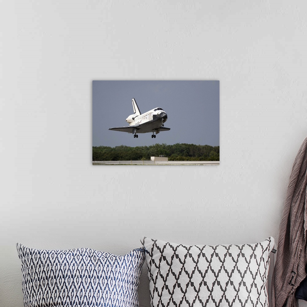 A bohemian room featuring Space Shuttle Discovery approaches landing on the runway at the Kennedy Space Center