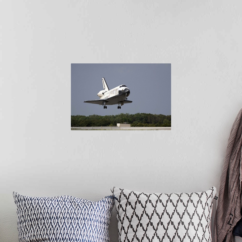 A bohemian room featuring Space Shuttle Discovery approaches landing on the runway at the Kennedy Space Center