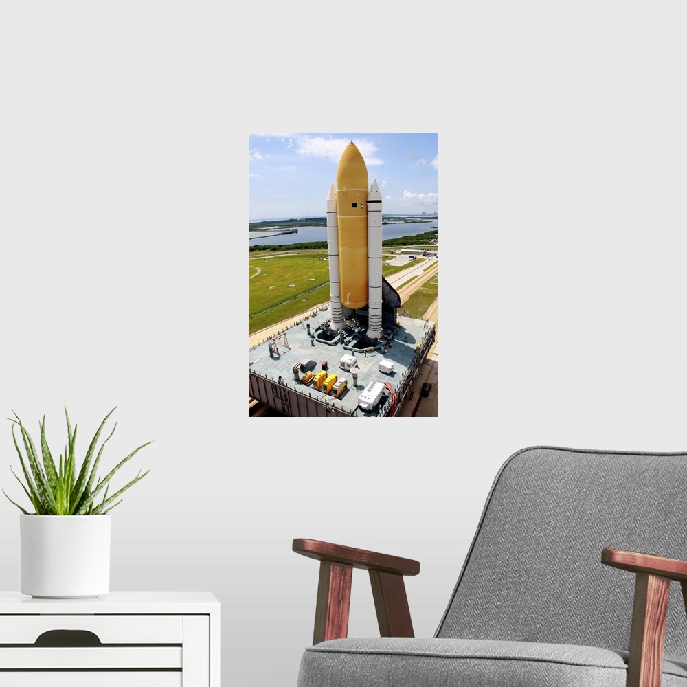 A modern room featuring Space Shuttle Discovery atop the mobile launcher platform