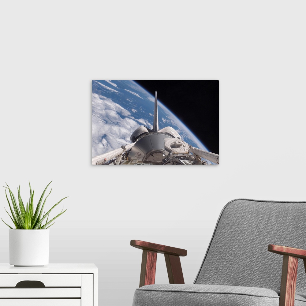 A modern room featuring Space Shuttle Discovery backdropped by Earth