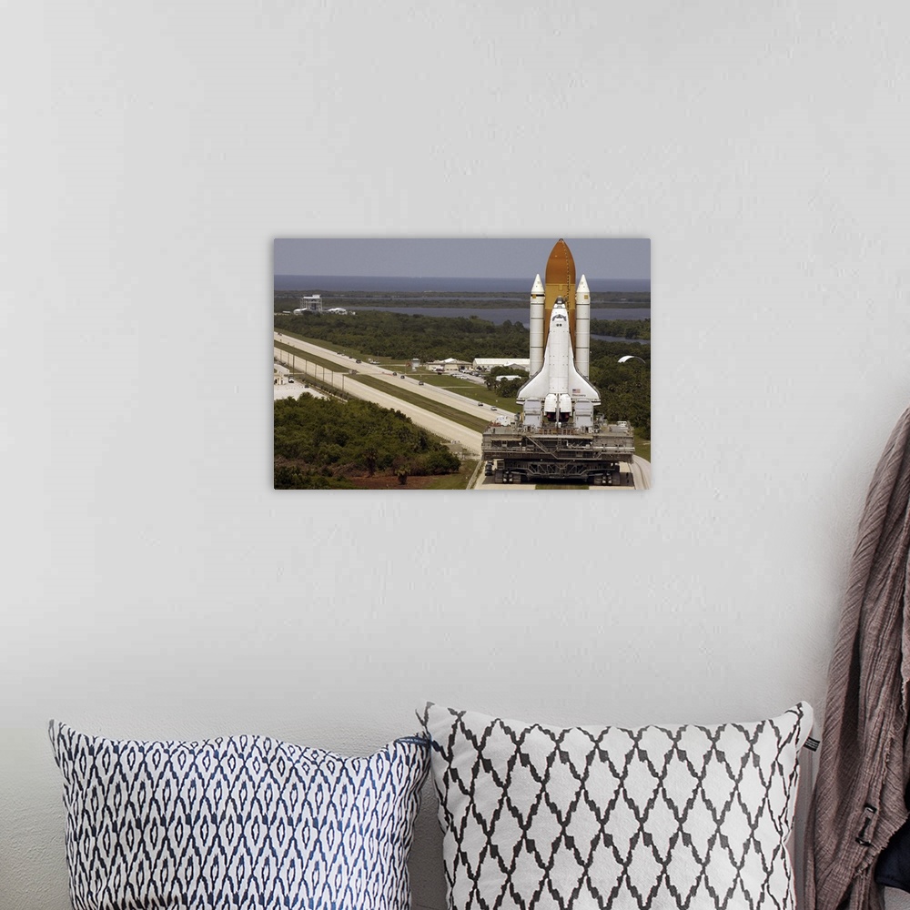A bohemian room featuring Space Shuttle Discovery resting on the Mobile Launcher Platform