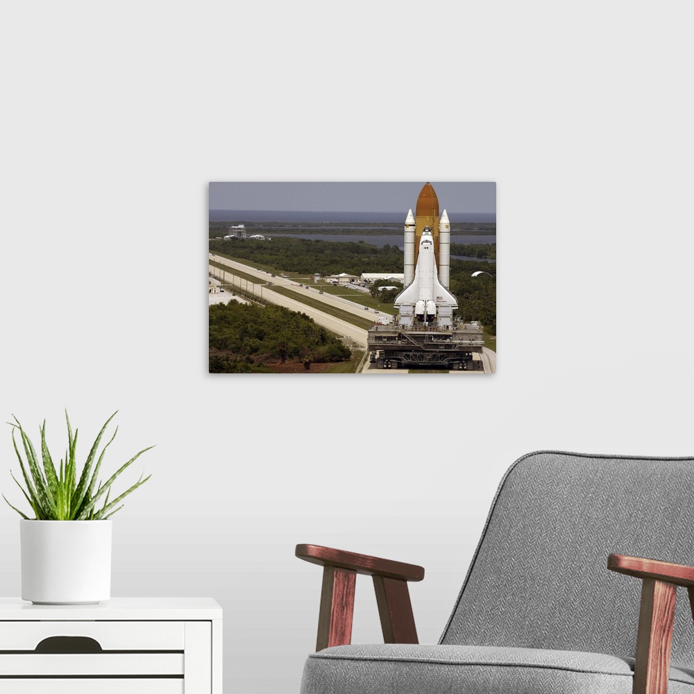A modern room featuring Space Shuttle Discovery resting on the Mobile Launcher Platform