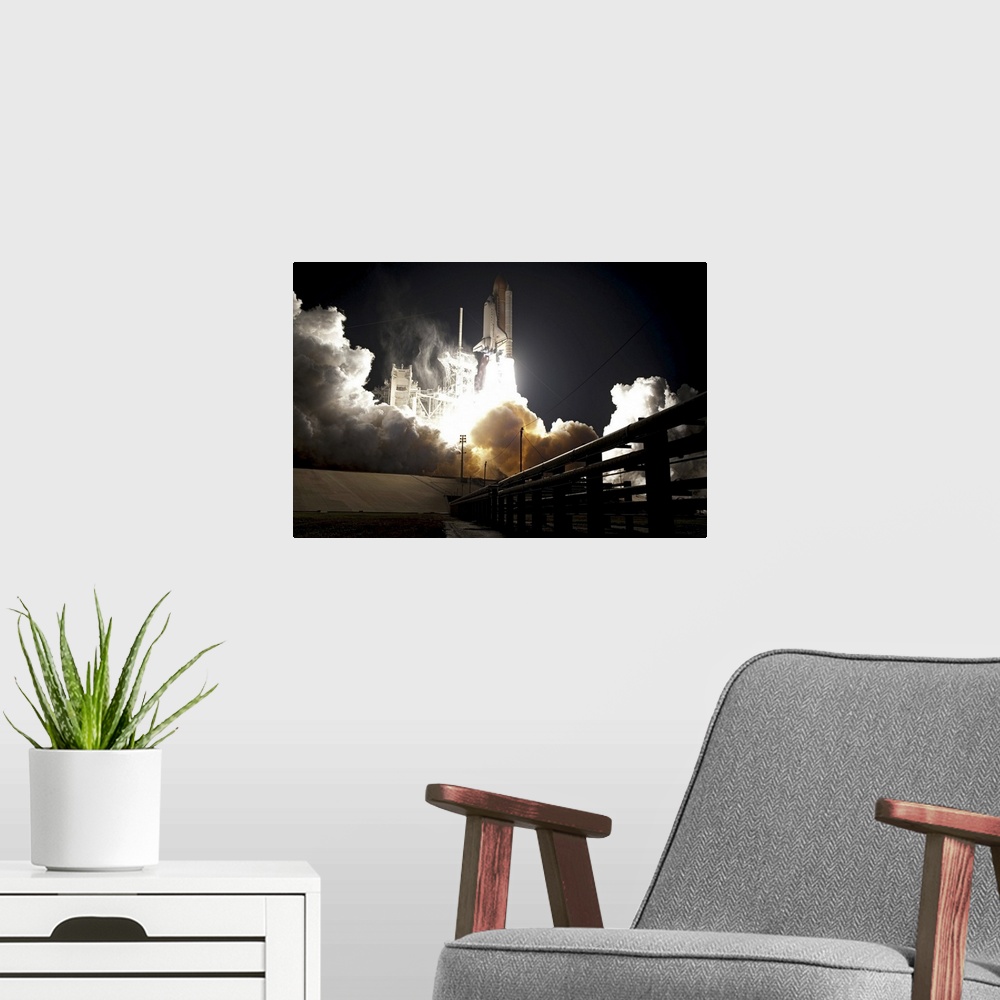 A modern room featuring Large horizontal photograph of the space shuttle Endeavour taking off from the launch pad at nigh...