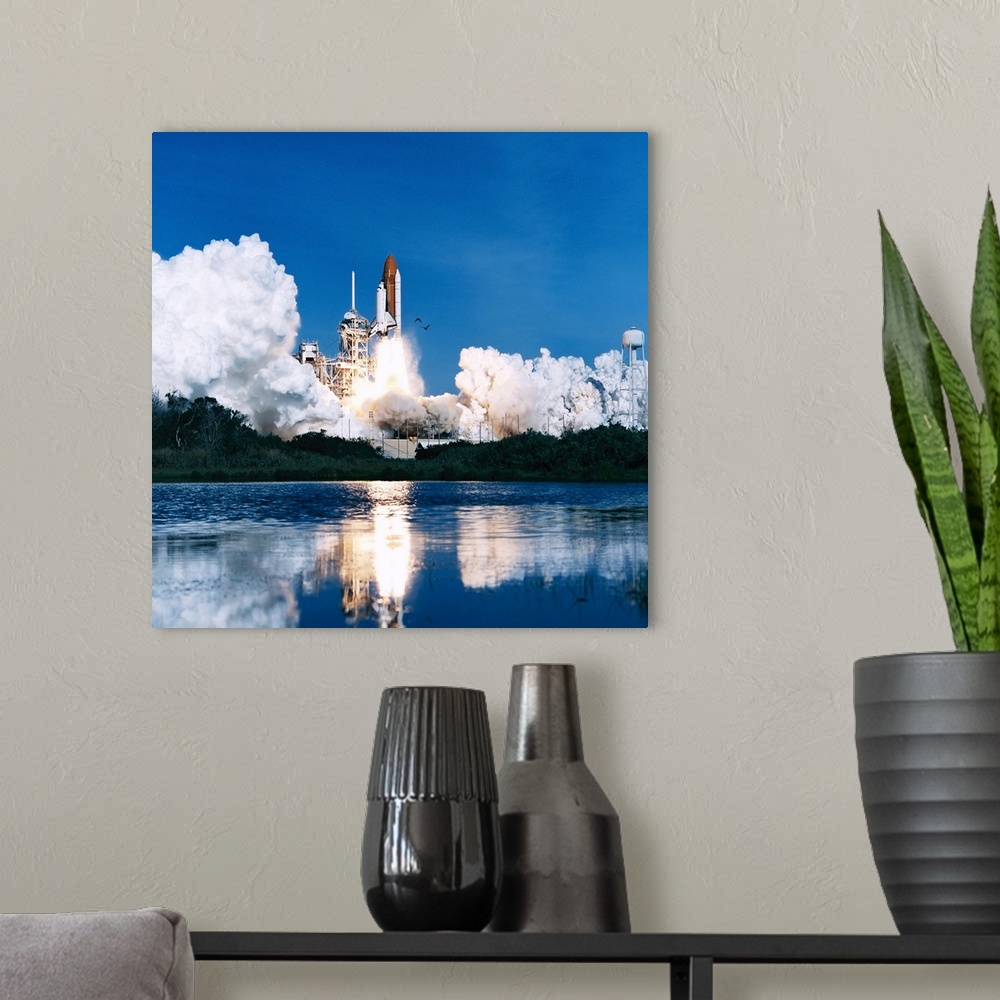A modern room featuring A space shuttle launching into space on a bright clear day over the water.
