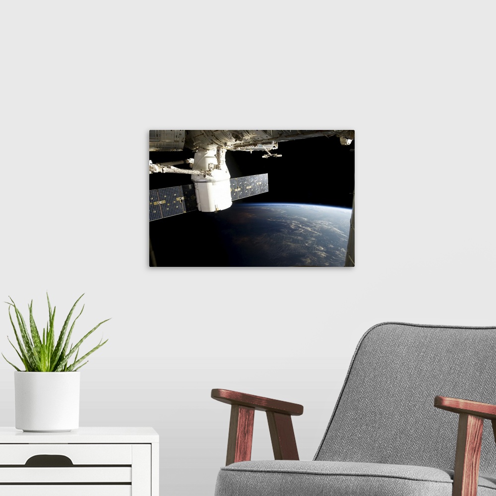 A modern room featuring March 3, 2013 - View of the SpaceX Dragon during its approach and docking with the International ...