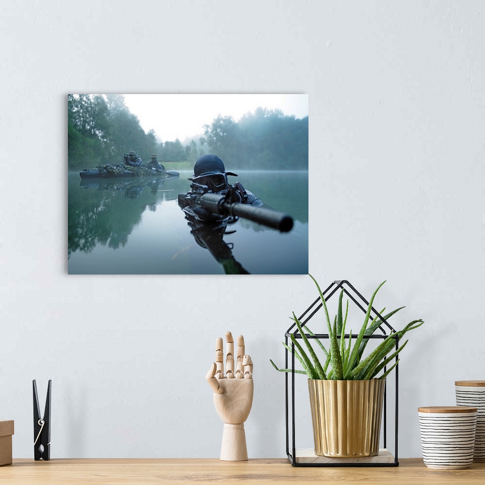A bohemian room featuring Landscape photograph of a special operations forces combat diver just above foggy water,  armed w...