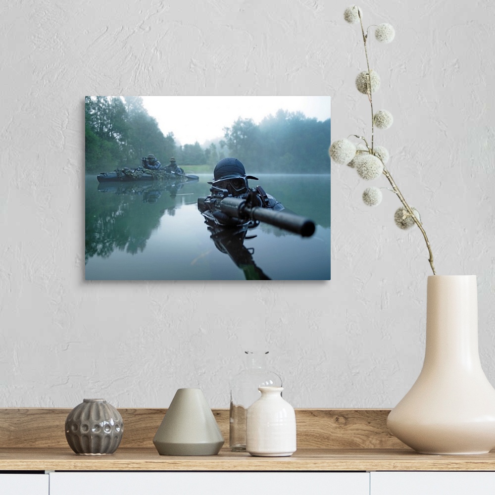 A farmhouse room featuring Landscape photograph of a special operations forces combat diver just above foggy water,  armed w...