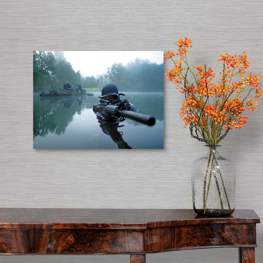 A traditional room featuring Landscape photograph of a special operations forces combat diver just above foggy water,  armed w...