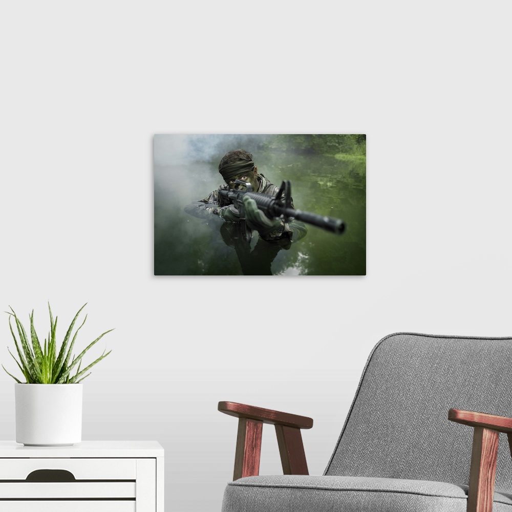 A modern room featuring Special operations forces soldier transits the water armed with an assault rifle.