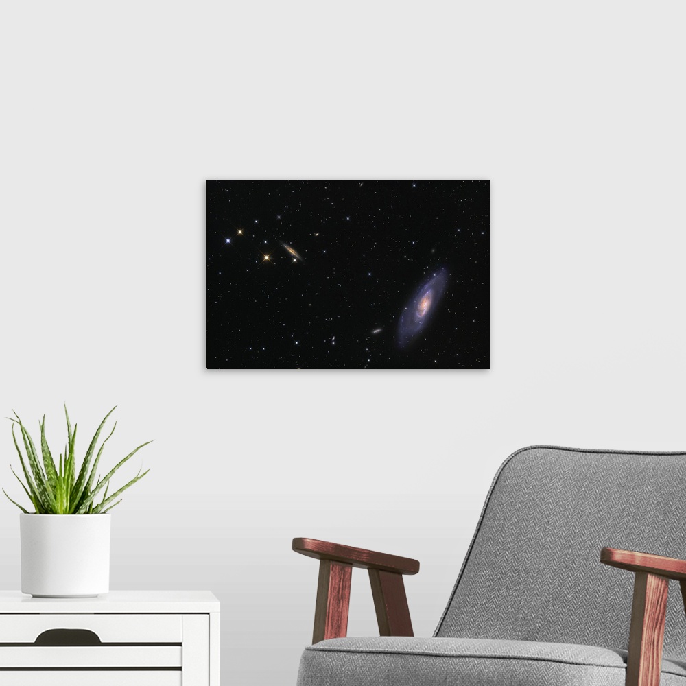 A modern room featuring Spiral galaxy Messier 106.