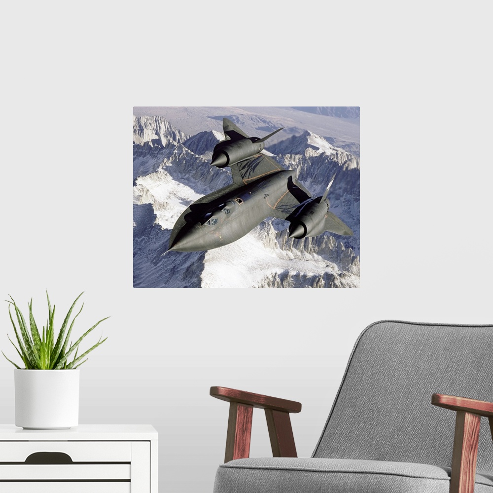 A modern room featuring A Lockheed SR-71 Blackbird spy plane flies over a mountain range as the sun shines down.
