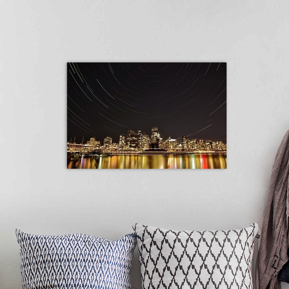 A bohemian room featuring Landscape, big photograph of the Vancouver skyline at night, under a large sky with circular patt...
