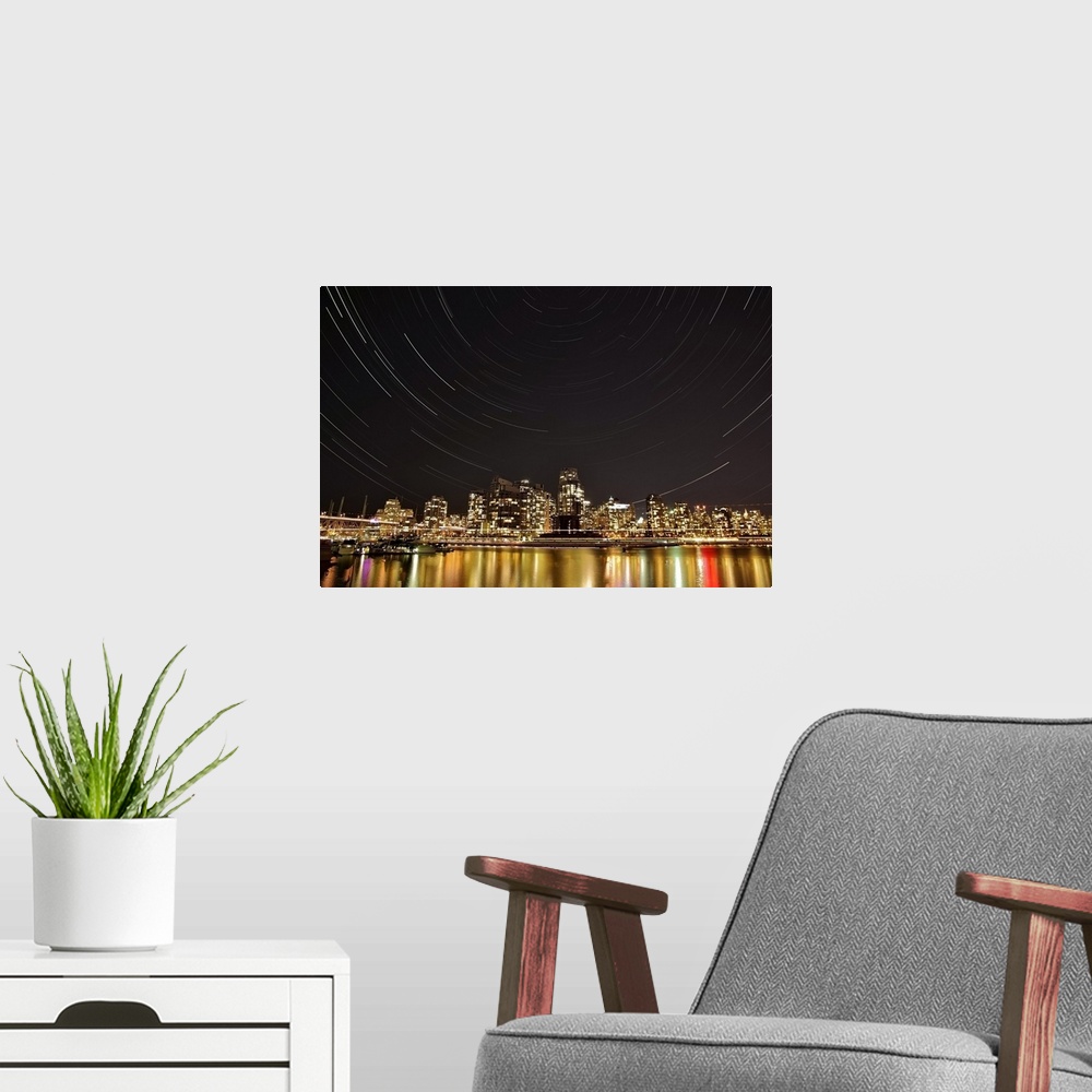 A modern room featuring Landscape, big photograph of the Vancouver skyline at night, under a large sky with circular patt...