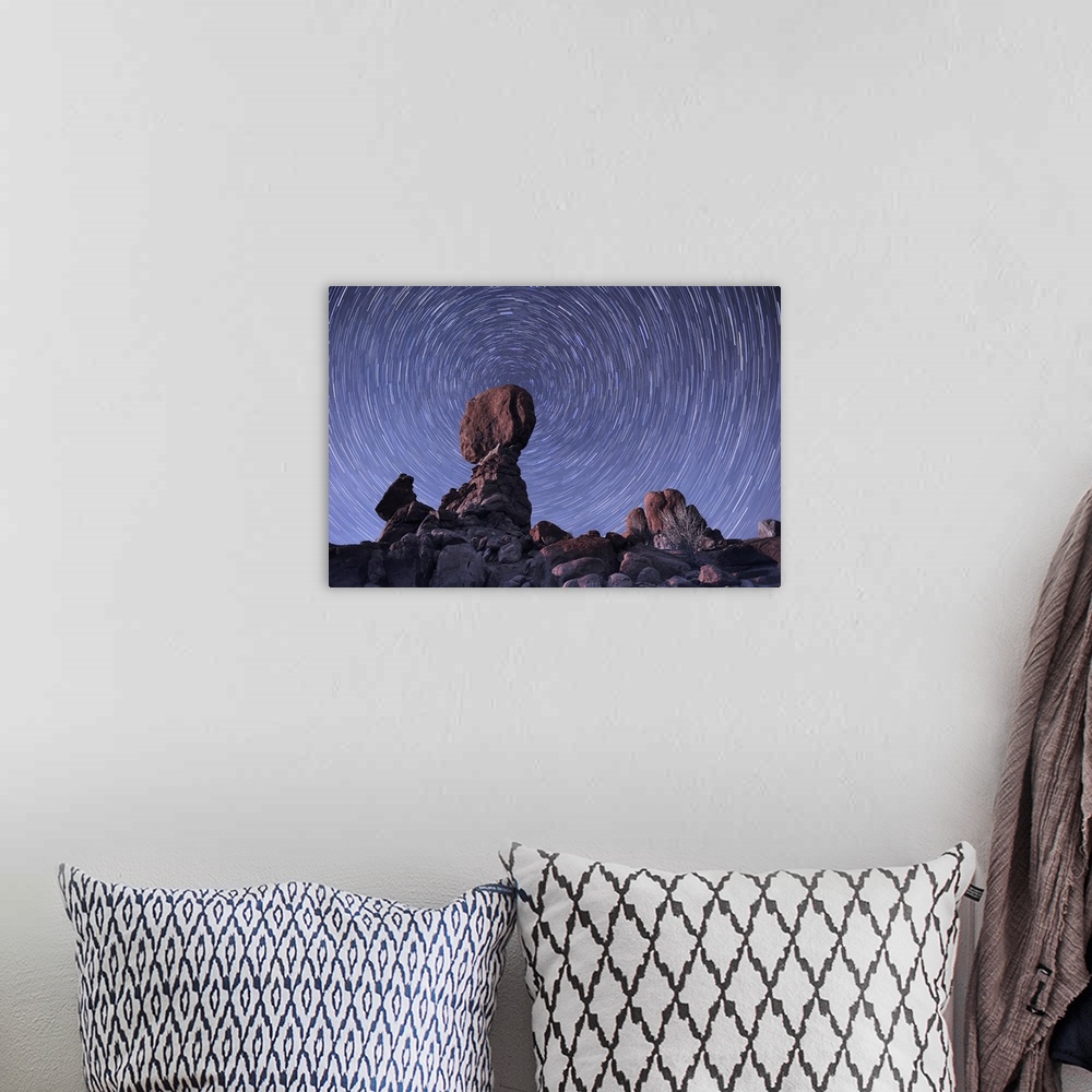 A bohemian room featuring The stars trail around the northern pole star with the famous Balance Rock in the foreground, Arc...