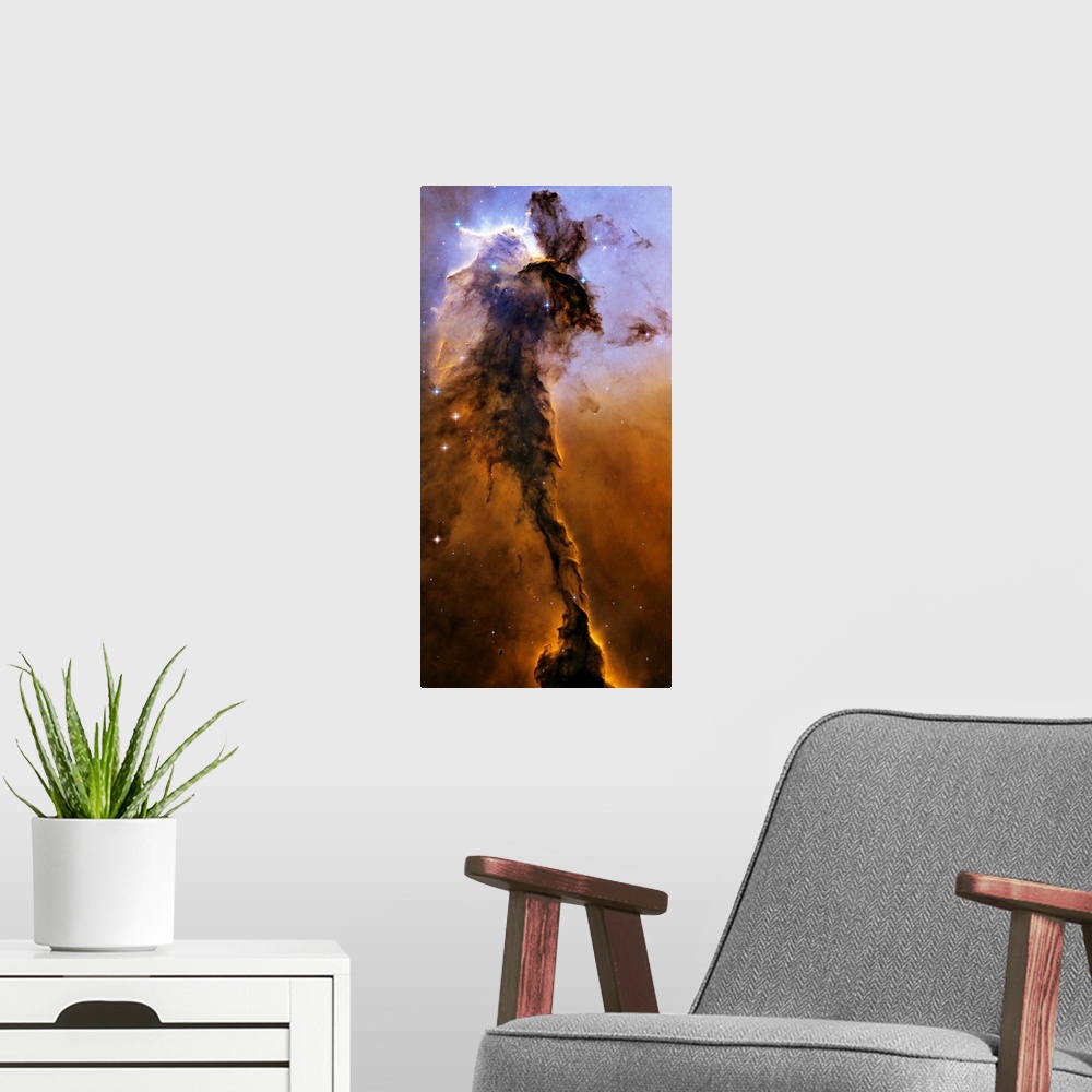 A modern room featuring Oversized, vertical wall picture of bright stars and the Stellar Spire in the Eagle Nebula.