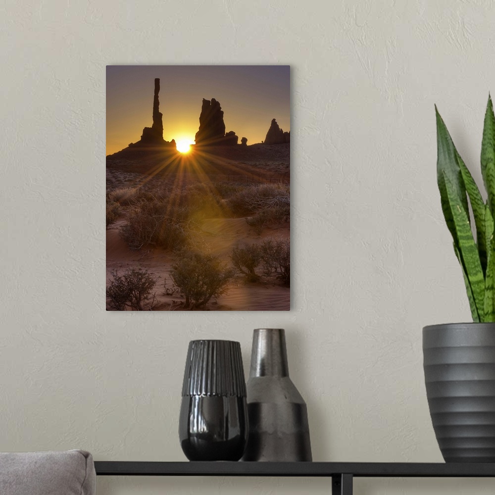 A modern room featuring A sunburst through the famous Totem Pole formation in Monument Valley, Utah.