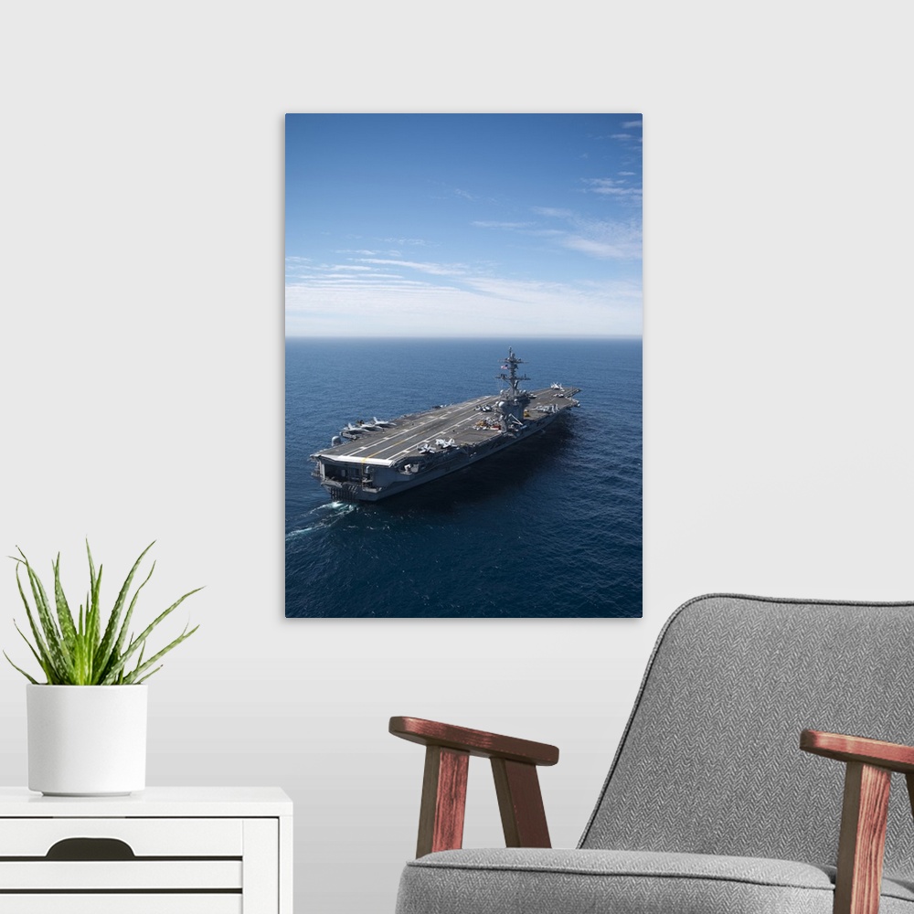 A modern room featuring The aircraft carrier USS Carl Vinson in the Pacific Ocean.