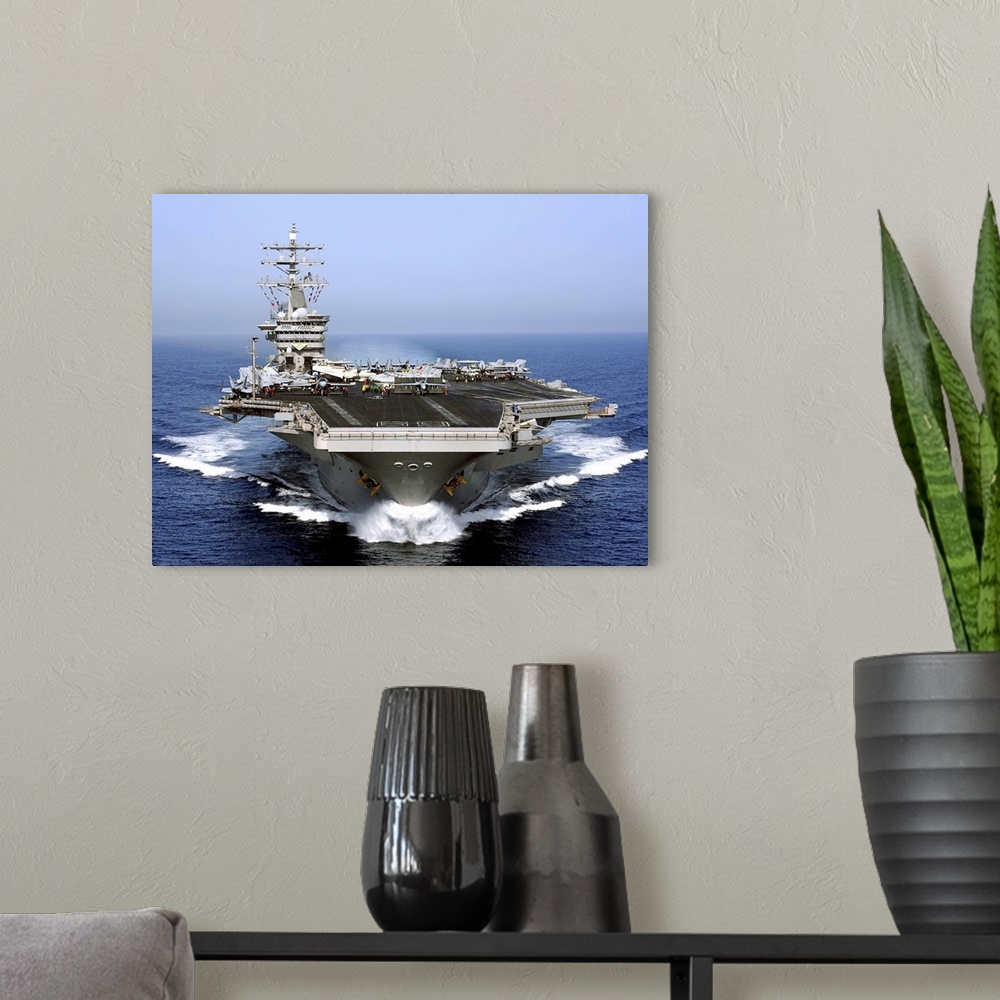 A modern room featuring The aircraft carrier USS Dwight D. Eisenhower transits the Arabian Sea.