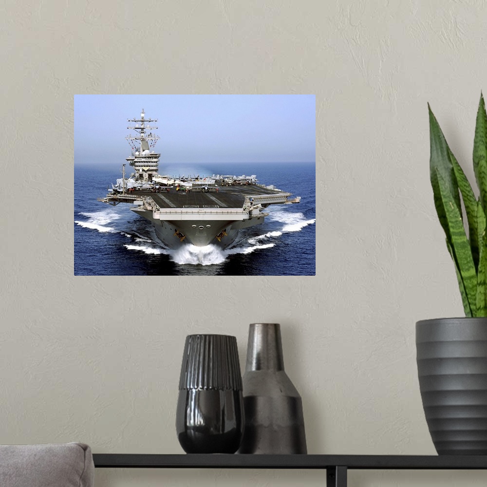 A modern room featuring The aircraft carrier USS Dwight D. Eisenhower transits the Arabian Sea.