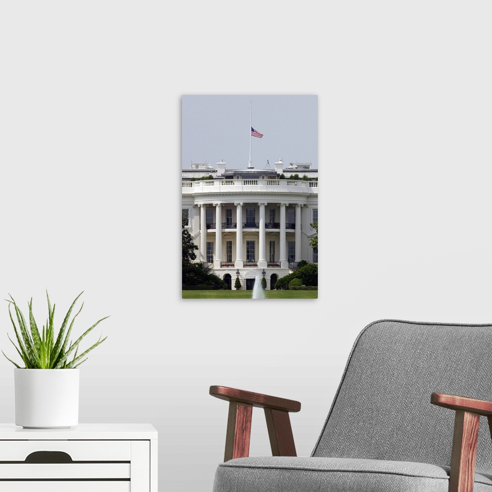 A modern room featuring The American flag flies at half-staff atop the White House.