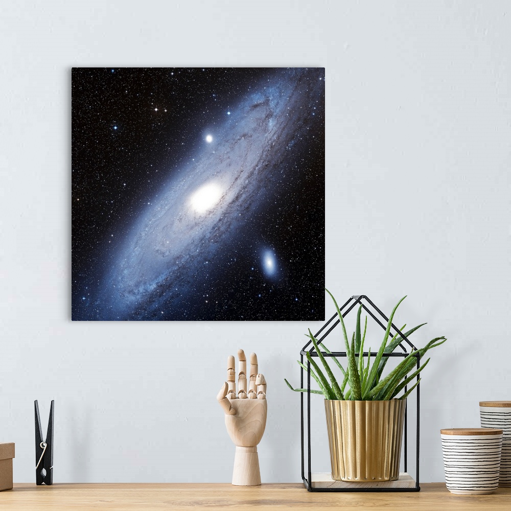 A bohemian room featuring Photograph of star system with diagonally slanted oval shaped cloud of gas.