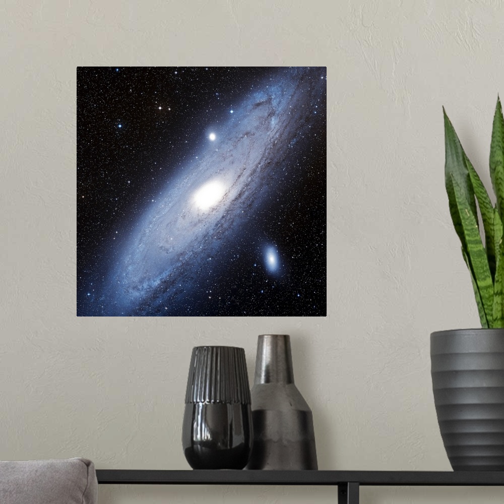 A modern room featuring Photograph of star system with diagonally slanted oval shaped cloud of gas.