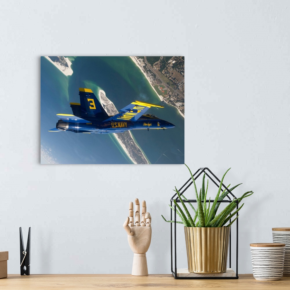 A bohemian room featuring The Blue Angels perform a looping maneuver over Naval Air Station Pensacola.
