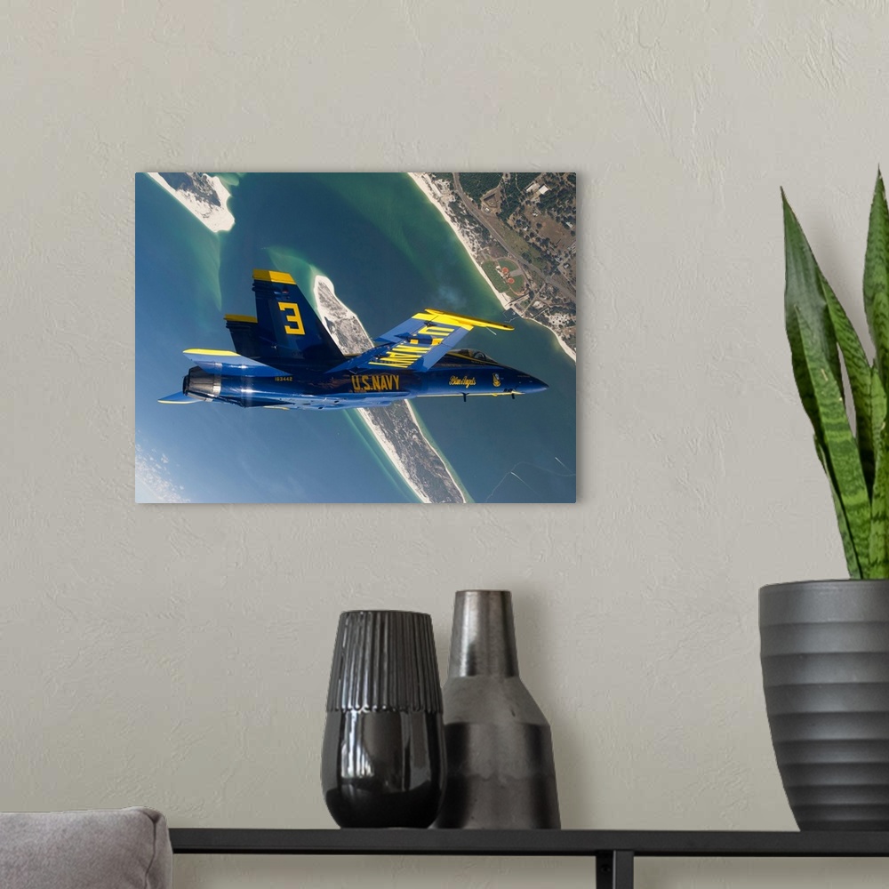 A modern room featuring The Blue Angels perform a looping maneuver over Naval Air Station Pensacola.